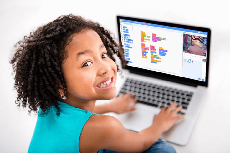 Teenagers and young adults collaborating together on digital designs